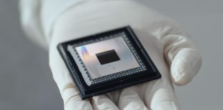 Google’s Willow Chip: A New Era of Quantum Computing A close-up of Google's Willow quantum computing chip held delicately in a gloved hand, symbolizing advanced technological innovation.