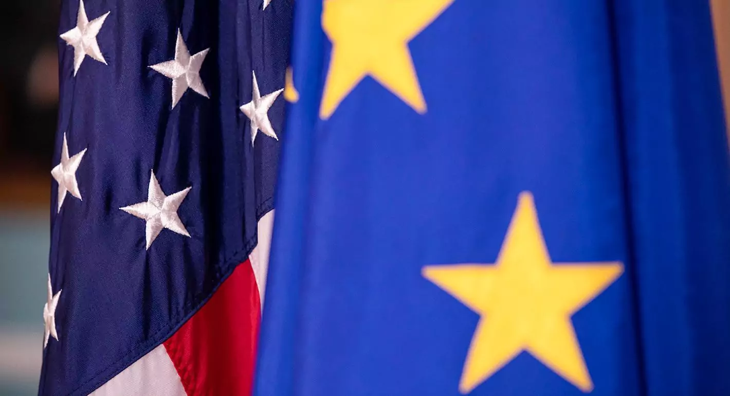 The Changing Transatlantic World: A Shift in US-EU Relations A split image of the US and European flags symbolizing the changing transatlantic relations.